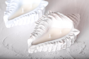 A candle in the shape of a shell. Plaster mold. Soy wax candle, inner candle.