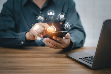 Man uses smartphone and laptop with cloud computing diagram show on hand. payment concept online with the internet and working in office