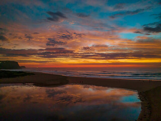 Dawn reflections and clouds at the seaside with lagoon