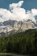 Mount Zugspitze and lake Eibzee. Bavarian Alps. Germany. Beautiful mountain landscapes are visible from the forest.
