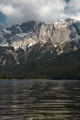 Mount Zugspitze and lake Eibzee. Bavarian Alps. Germany. Beautiful mountain landscapes are visible from the forest.