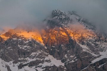 Sunset. Mount Zugspitze. Bavarian Alps. Germany. Beautiful mountain landscapes are visible from the forest.