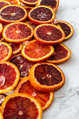 Fruit background with blood oranges and ice, delicious sweet fruit, copy space