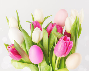 Easter holiday composition with beautiful spring bouquet of white and pink tulips with decorative easter eggs on a white background with bokeh effect. Soft focus style