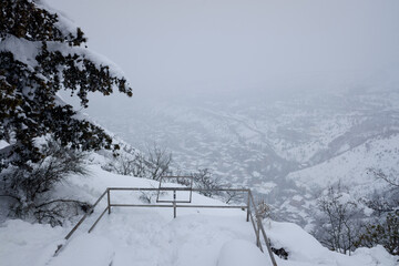 view from the mountain to the snow-covered city