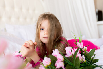 Portrait of a cute little girl with flowers. Spring portrait. Mothers Day.
