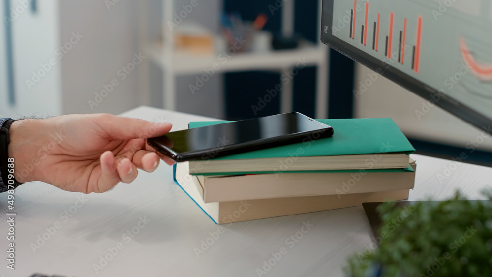 Poster office employee checking text message on smartphone, browsing internet after working on financial st