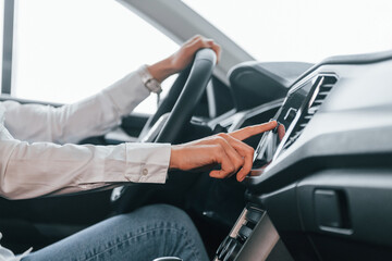 Close up view of front panel. Woman is in autosalon at daytime