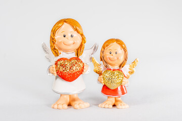 angel statue isolated on white background. Figurine of an angel on a white background. Ceramic angel isolated.