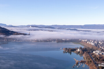 Sunrise above the deep misty valley and Annecy lake, early morning with fog above the lake and forest, the scenery and the landscape of the Annecy, France