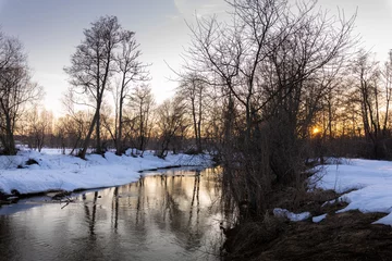 Foto auf Leinwand Winter landscape, trees near the river against the backdrop of sunset. © Sergei