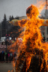 Russian traditional holiday Shrovetide. The scarecrow is on fire. End of carnival.