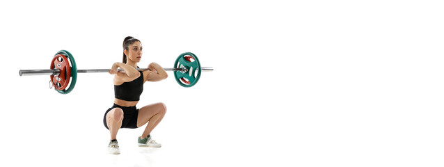Obraz premium Full length portrait of muscled woman in sportswear exercising with a weight, barbell isolated on white background. Sport, weightlifting concept