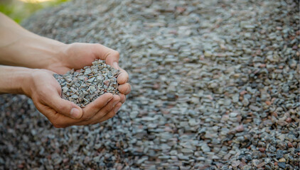 Man holding small rubble in his hands selective focus