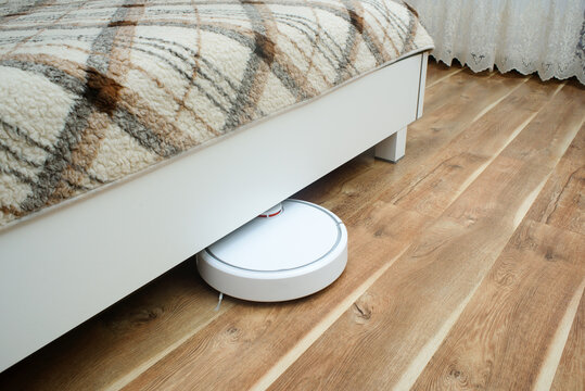 robotic vacuum cleaner cleaning the room - Powered by Adobe
