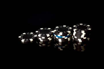 Pile black chips received as result of winning. Successful combination in the casino. Luck or fortune in a poker club