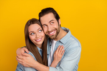 Photo of dreamy funny husband wife wear jeans shirts cuddling looking empty space isolated yellow color background