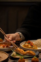 Sushi eating with a chopstick in hand