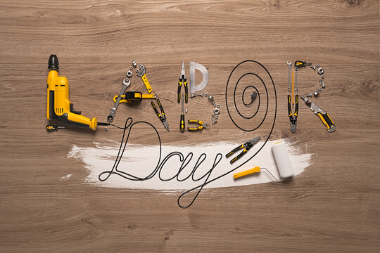 The LABOR DAY phrase laid out from a set of construction tools and a drill wire. Creative congratulatory design template for building, engineering or maintenance companies. 3d render.