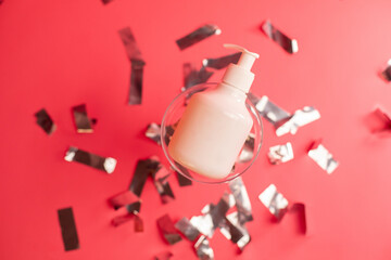 Mockup of beauty cosmetic makeup bottle product with skincare healthcare in glass concept on pink background with celebration confetti.