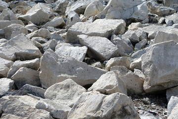 large pieces of rocks placed in front of ponds,