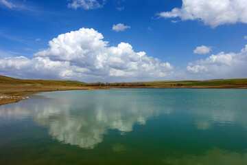 wonderful spring landscape of sky lake and clouds,clouds reflecting in water,