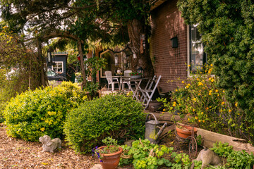 Garden with a garden sculpture and flowering trees and bushes in a quiet Dutch village.