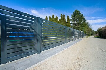 Metal fence on the road in the countryside