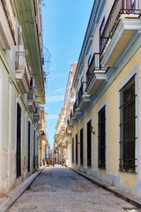 Narrow paved street of old Havana, Cuba. Facades of colonial buildings.