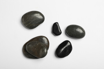 Many different stones on white background, top view