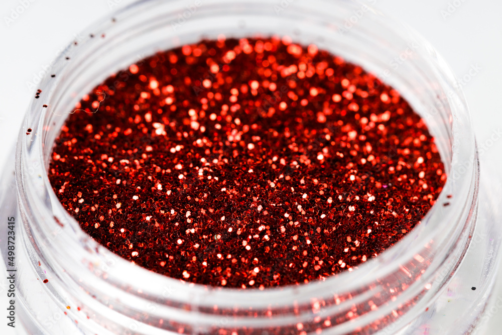 Poster colored sequins in a plastic jar close-up