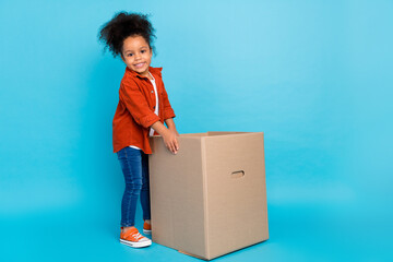 Full size photo of optimistic wavy small girl pack box wear shirt jeans shoes isolated on blue...