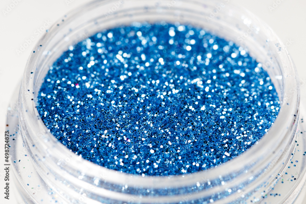 Poster colored sequins in a plastic jar close-up