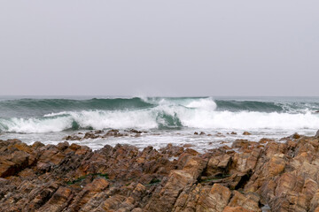 Ocean waves energy, breaking waves. Surfing waves, swell and wave direction. On shore view to ocean waves breaking. Ocean coast backgrounds. 