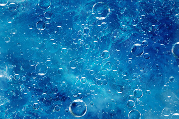 large air bubbles under water, blue background - obrazy, fototapety, plakaty