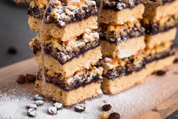 Shortbread biscuits stacked close up. Pie sprinkled with powdered sugar.