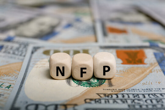 Cubes with abbreviation NFP on dollar bills