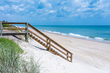 An excellent beach in Melbourne Beach and stairs descending to the inviting green Atlantic Ocean in...