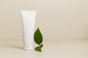 Mockup face cream tube with green leaf, eco friendly natural care cosmetic template, copy space, pastel color