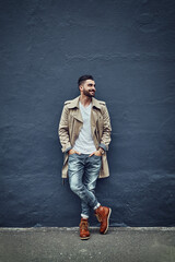 Style thats hot off the street. Shot of a fashionable young man wearing urban wear and posing against a gray wall.