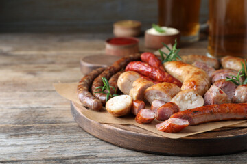 Set of different tasty snacks and beer on wooden table, closeup view. Space for text