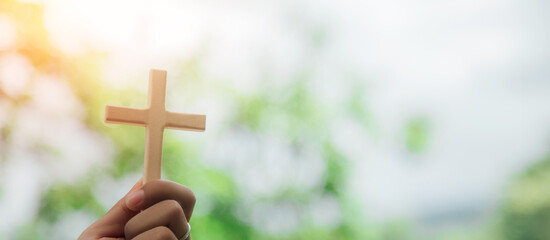 wooden cross on hand and religious ideas.