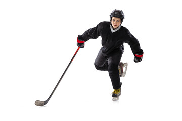 Active player. Sportive boy, child, hockey player in special uniform training, practising isolated over white studio background.