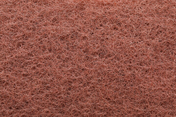 Brown abrasive cleaning sponge as background, top view