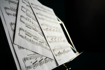 Music sheet on music stand with black background
