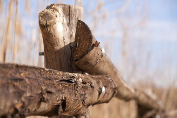 Weathered wooden fence with metal screws