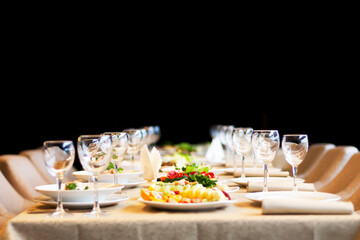 Snacks and glasses for wine set in restaurant