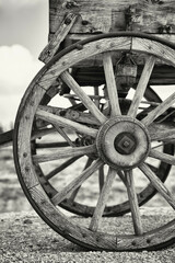 Fototapeta na wymiar Old wagon wheel with sepia processing.