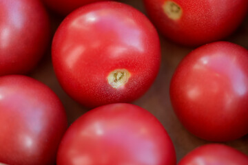 Ripe juicy healthy tomatoes in a box closeup