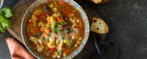 plate with traditional italian vegetable minestrone soup on the table - obrazy, fototapety, plakaty
